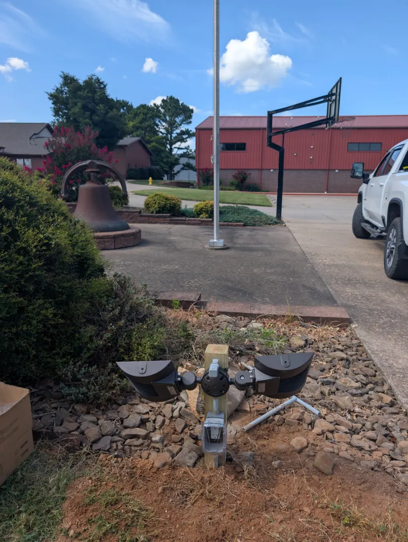 A new post-mounted pair of LED floodlights set in a rock bed below a flagpole