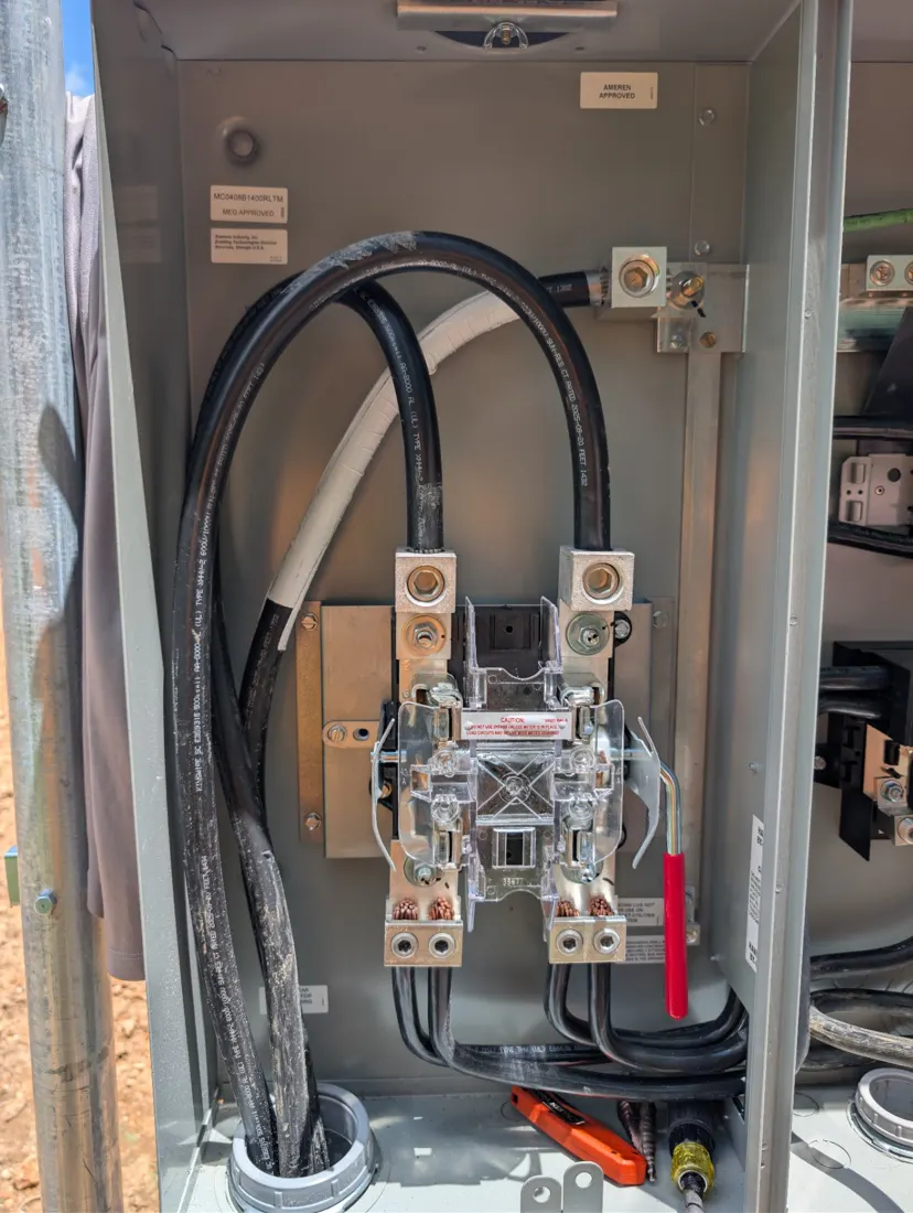 Inside new service equipment: heavy service conductors landed on the meter jaws and main lugs